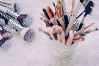 Makeup Brushes on White Fur Background