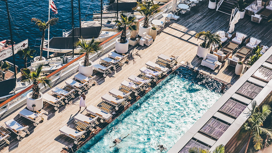 Aerial View of Luxury Marina Pool Deck with Yachts