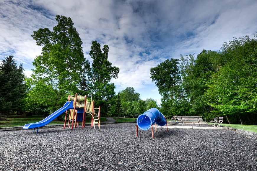 Empty playground with blue slide and tunnel in park