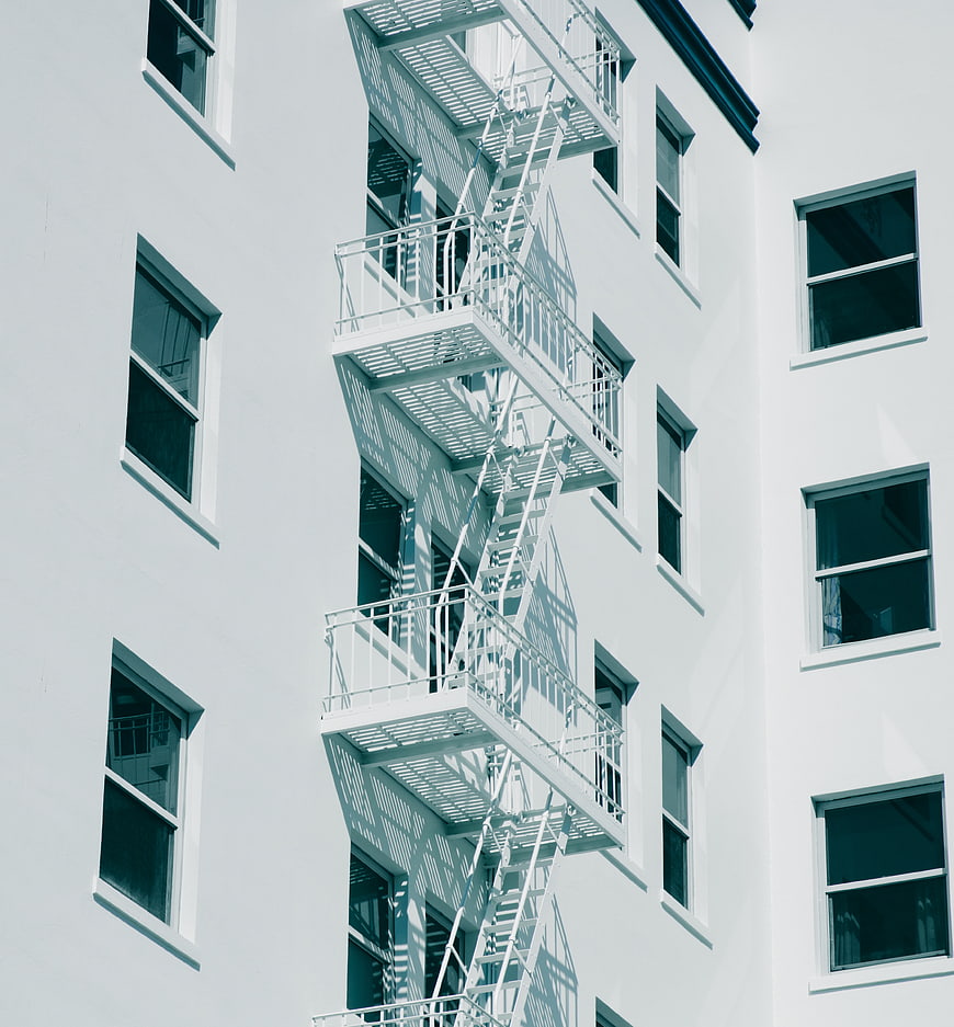 White Fire Escape Stairs on Urban Building Facade