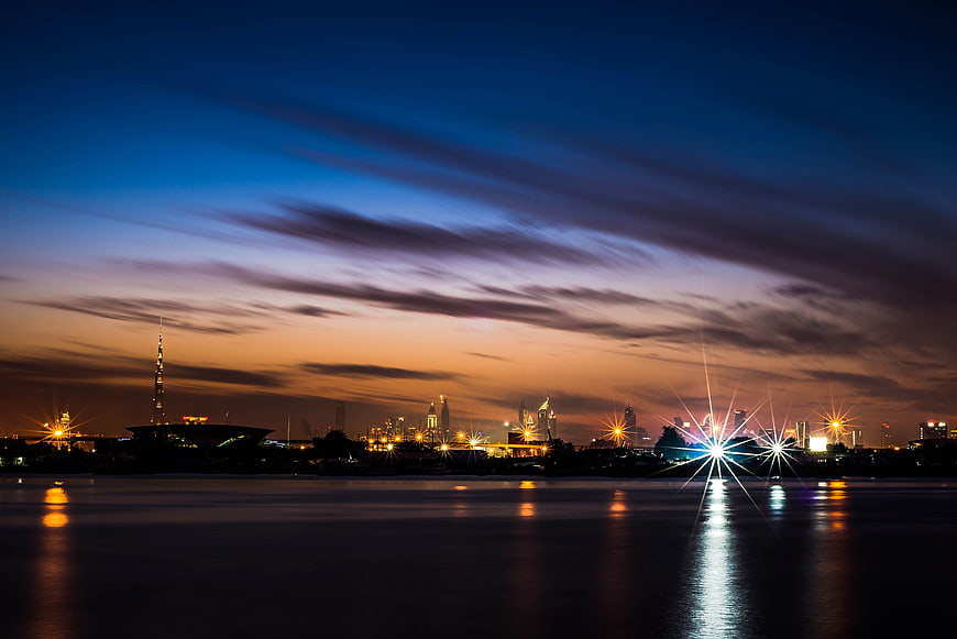 Dramatic city skyline at dusk with water reflections
