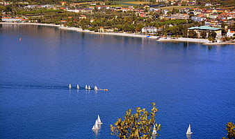 Sailboats on Lake Garda with Town Panorama