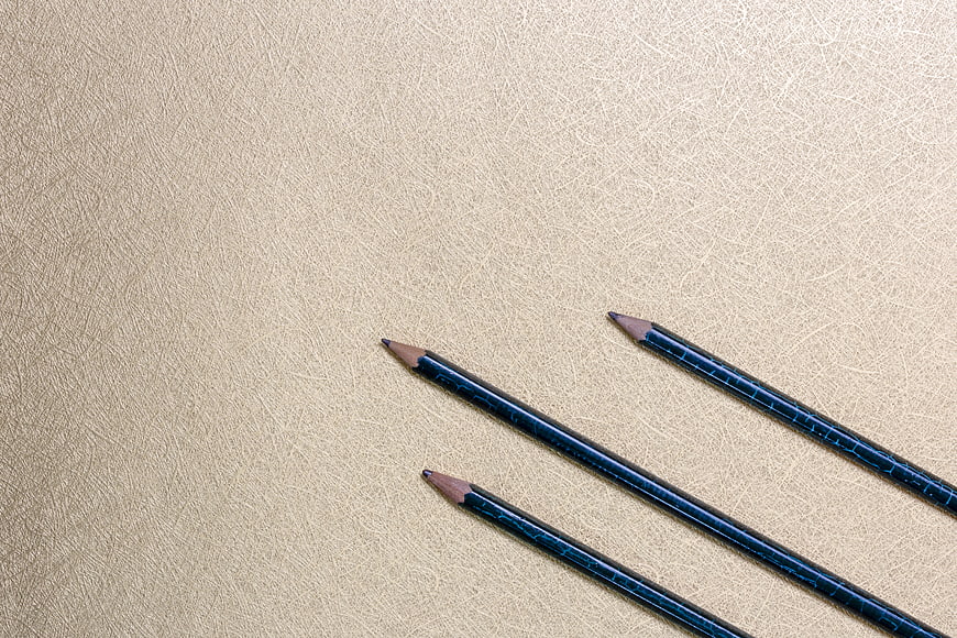 Blue Pencils on Textured Beige Background