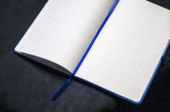 Open Blue Grid Notebook on Dark Surface