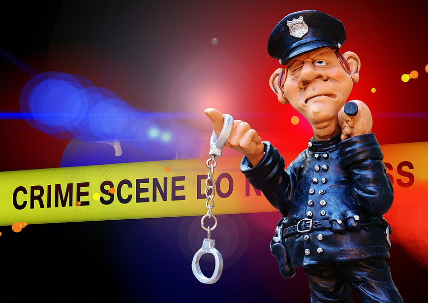 Police Officer Figurine Holding Handcuffs Against Crime Scene Tape Background