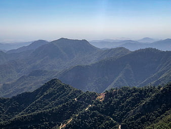 Scenic mountain landscape with winding road and blue sky