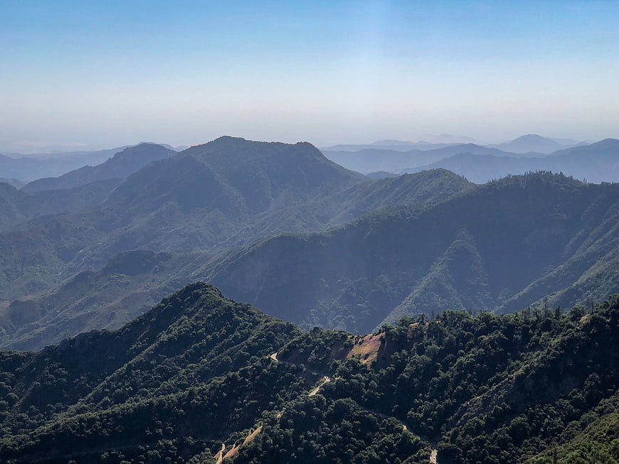 Scenic mountain landscape with winding road and blue sky