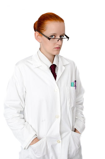 Serious female doctor in white lab coat with glasses