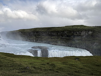 Majestic Gullfoss Waterfall in Iceland with Green Cliffs
