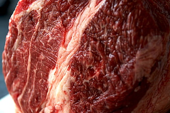 Close-up of raw marbled beef steak with rich red texture