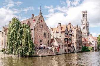Historic Bruges Canal with Belfry Tower and Weeping Willow
