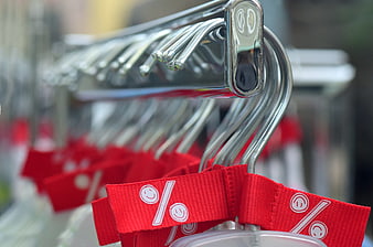 Red Discount Tags on Metal Hangers in a Clothing Store