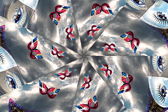 Kaleidoscope pattern of carnival masks and eyes on clouds