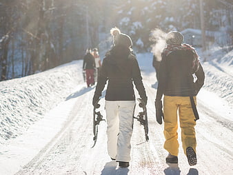Friends Walking with Snowshoes on Snowy Winter Path