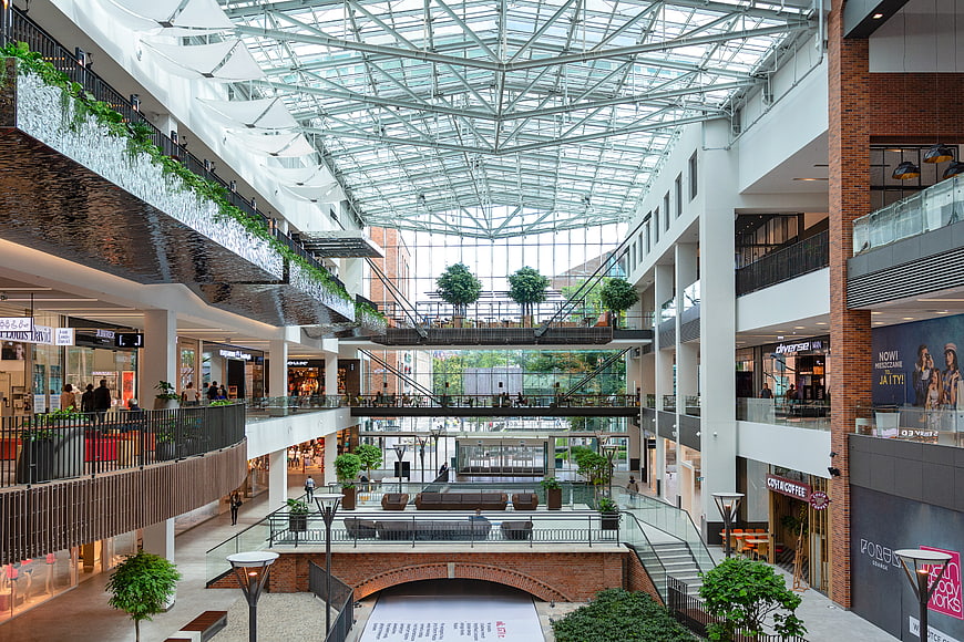 Modern Shopping Mall Interior With Glass Roof And Waterfall