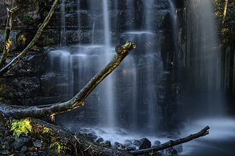 Misty waterfall in forest with long exposure