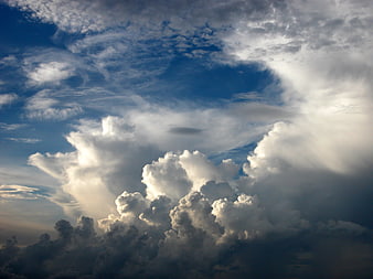 Dramatic Cumulus Clouds Against Deep Blue Sky