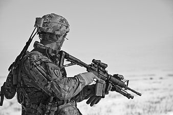 Soldier in Camouflage Holding Rifle in Black and White