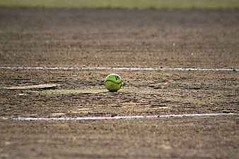 Softball on dirt field with white chalk lines