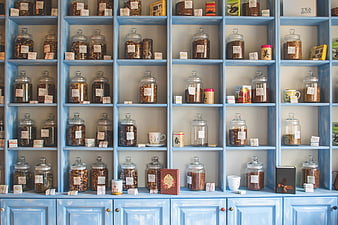 Blue Shelves With Glass Jars Of Herbs And Tea In A Shop