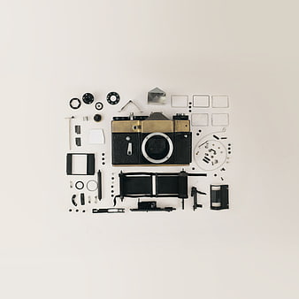 Disassembled vintage camera parts flat lay on white background