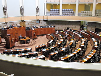 Interior of the Finnish Parliament Plenary Chamber with Seated Delegates