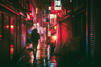 Woman with Umbrella Walking in Neon-Lit Rainy Alley at Night
