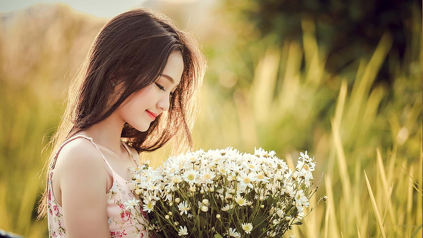 Young Asian Woman Holding White Daisies in Golden Field