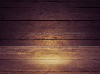Dark rustic wooden plank background with warm spotlight glow