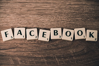 Facebook spelled with Scrabble tiles on wood