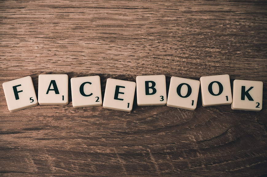 Facebook spelled with Scrabble tiles on wood