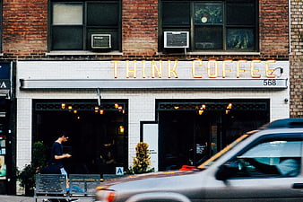 Think Coffee Neon Sign on Brick Building