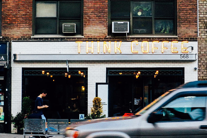 Think Coffee Neon Sign on Brick Building