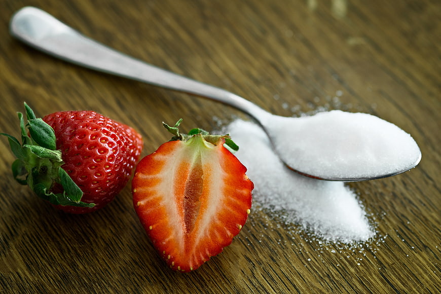 Fresh Strawberries and Spoon of Sugar on Wooden Table