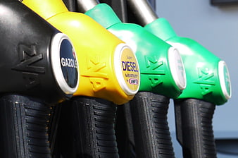 Close-up of Colorful Gas Pump Nozzles at a Station