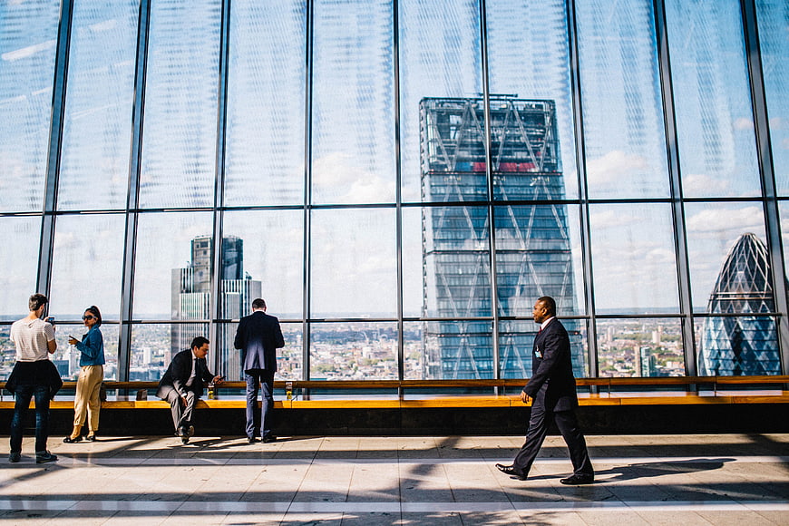 Businessmen in Modern Office with London Skyline View