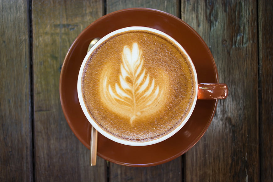 Top View of Latte Art on Rustic Wooden Table