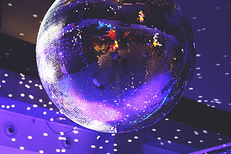 Purple Disco Ball With Light Reflections In Dark Dance Club