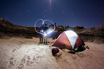 Couple Camping Under Starry Sky with Light Painting Heart
