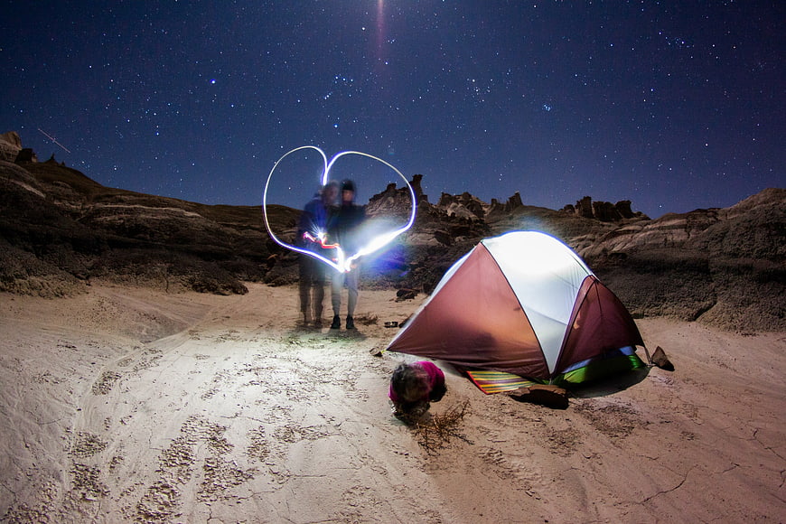 Couple Camping Under Starry Sky with Light Painting Heart