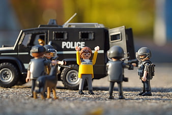 Playmobil police arrest scene with armored vehicle and suspect