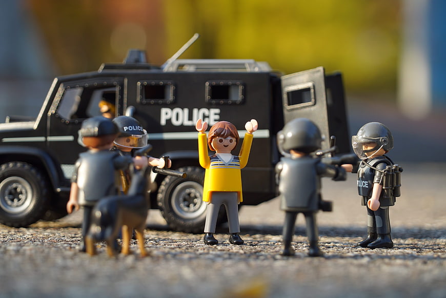 Playmobil police arrest scene with armored vehicle and suspect