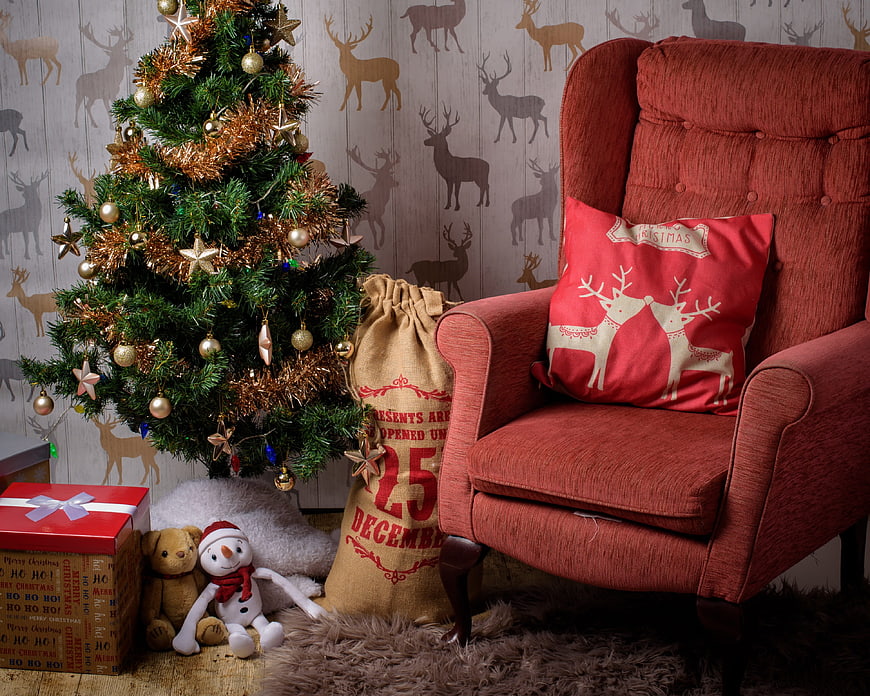 Cozy Christmas Corner With Red Armchair, Tree, And Holiday Decor