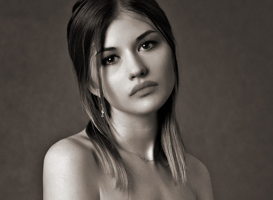Black and white portrait of a young woman with a melancholic expression