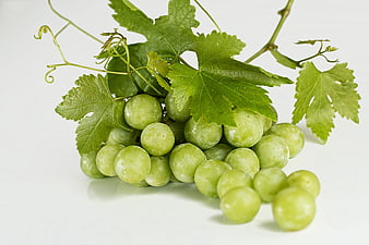 Fresh Green Grapes with Leaves on White Background