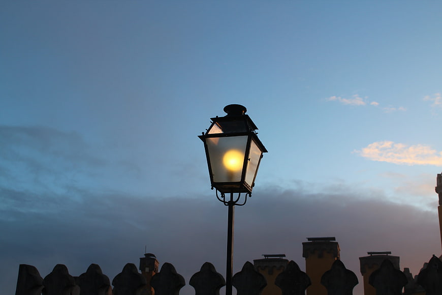 Vintage street lamp glowing against twilight sky