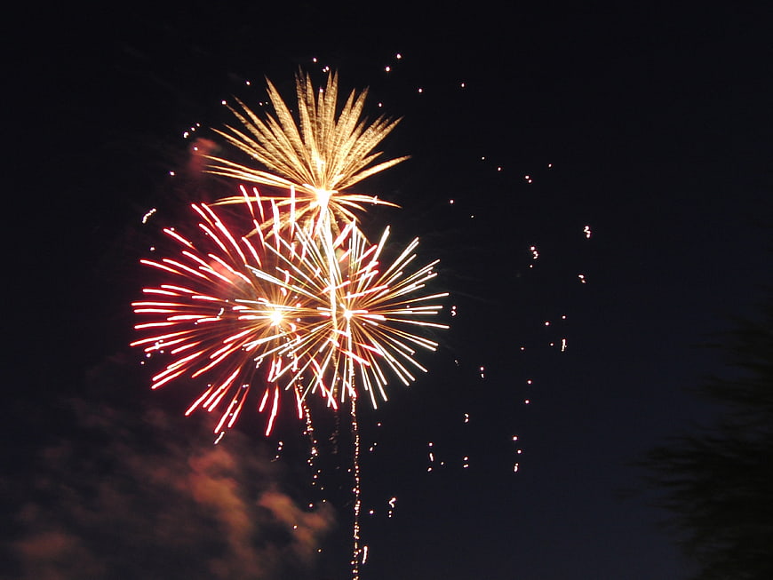 Colorful Fireworks Bursting In Night Sky