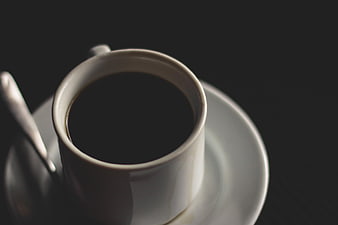 Top View of Black Coffee in White Cup on Dark Background