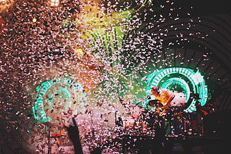 Live concert drummer performing under falling confetti