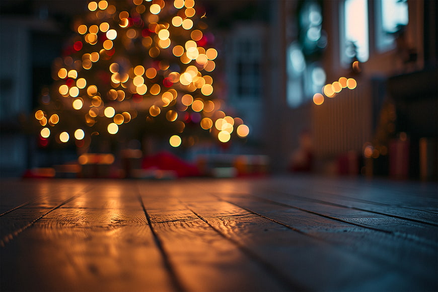 Rustic wooden table with blurred Christmas tree bokeh background